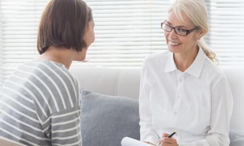 Psychiatric Mental Health Nurse Practitioner PMHNP Smiling with Adult Patient